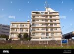 apartment-building-next-to-train-tracks-in-tokyo-japan-B4WH6B
